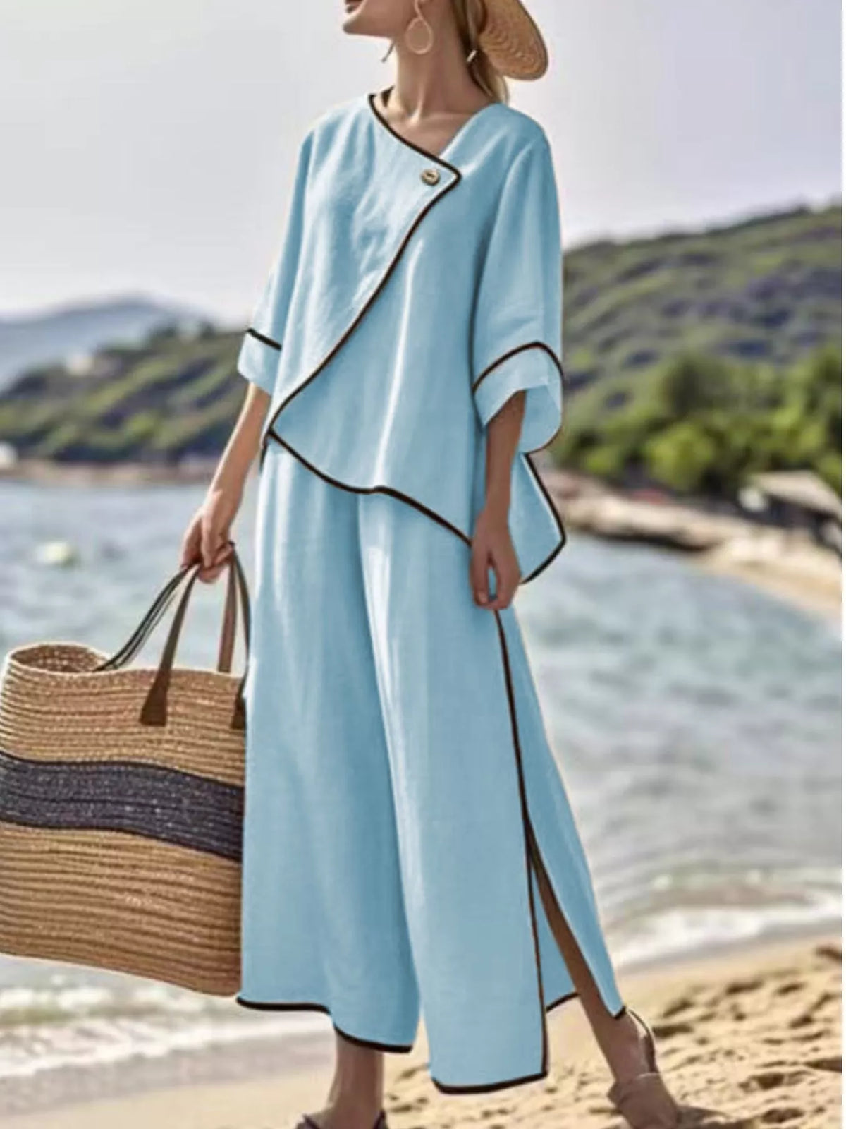 Light blue two-piece pants set with contrast trim, angled button top and wide-leg pants