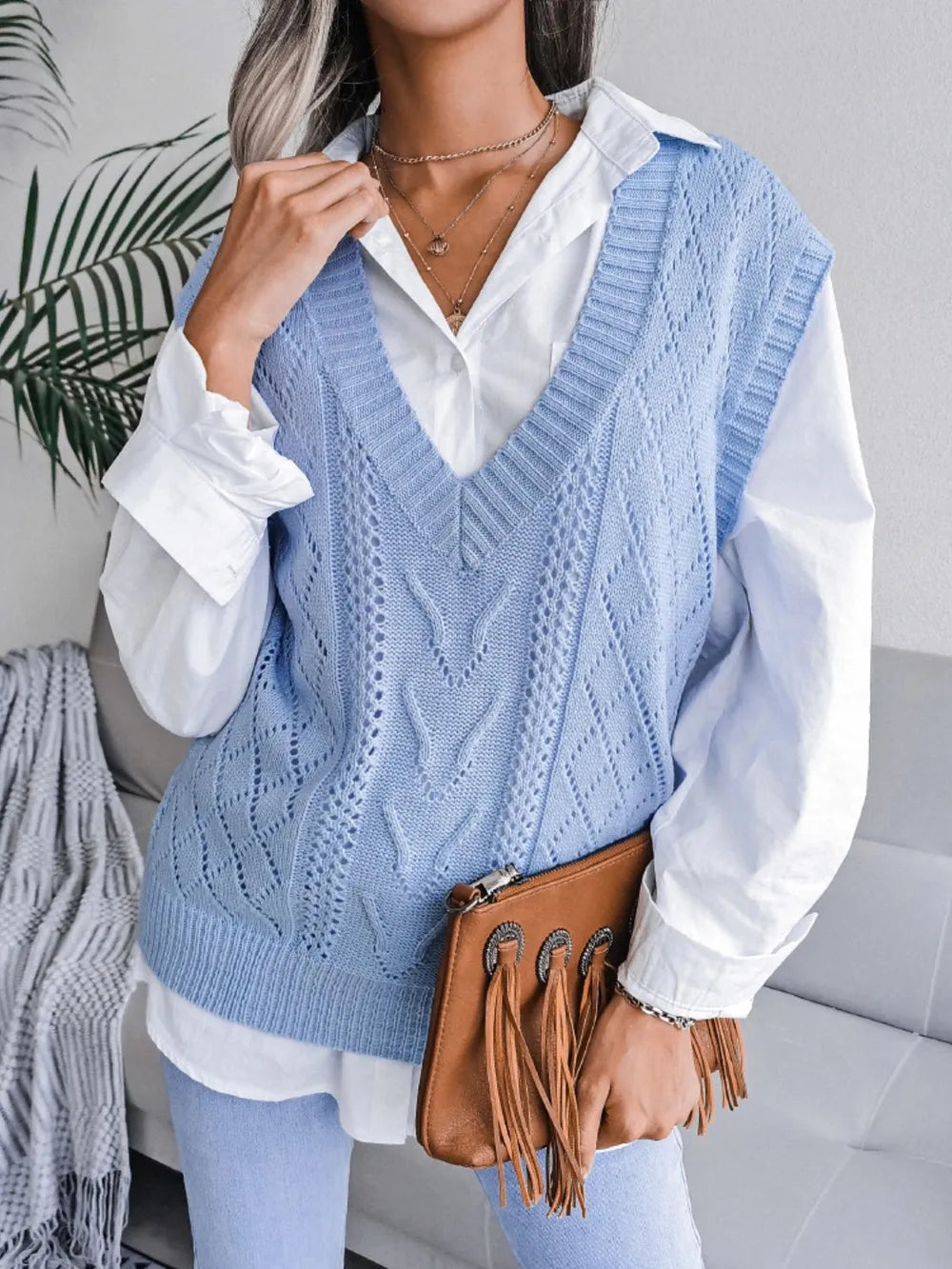 Light blue openwork V-neck sweater vest, sleeveless knit with textured diamond pattern.