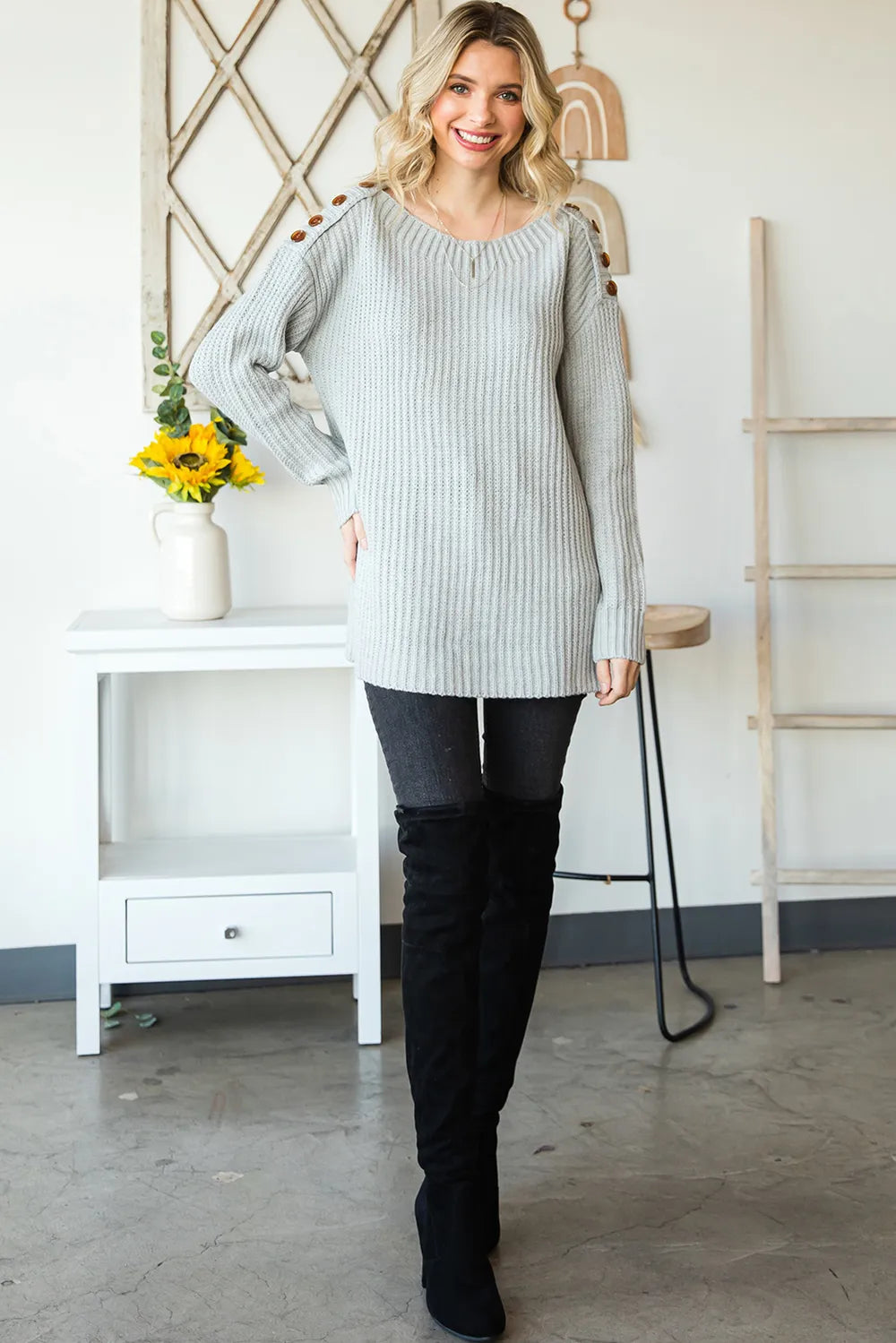 Light gray long-sleeve boat-neck sweater with side slits and buttoned shoulder accents