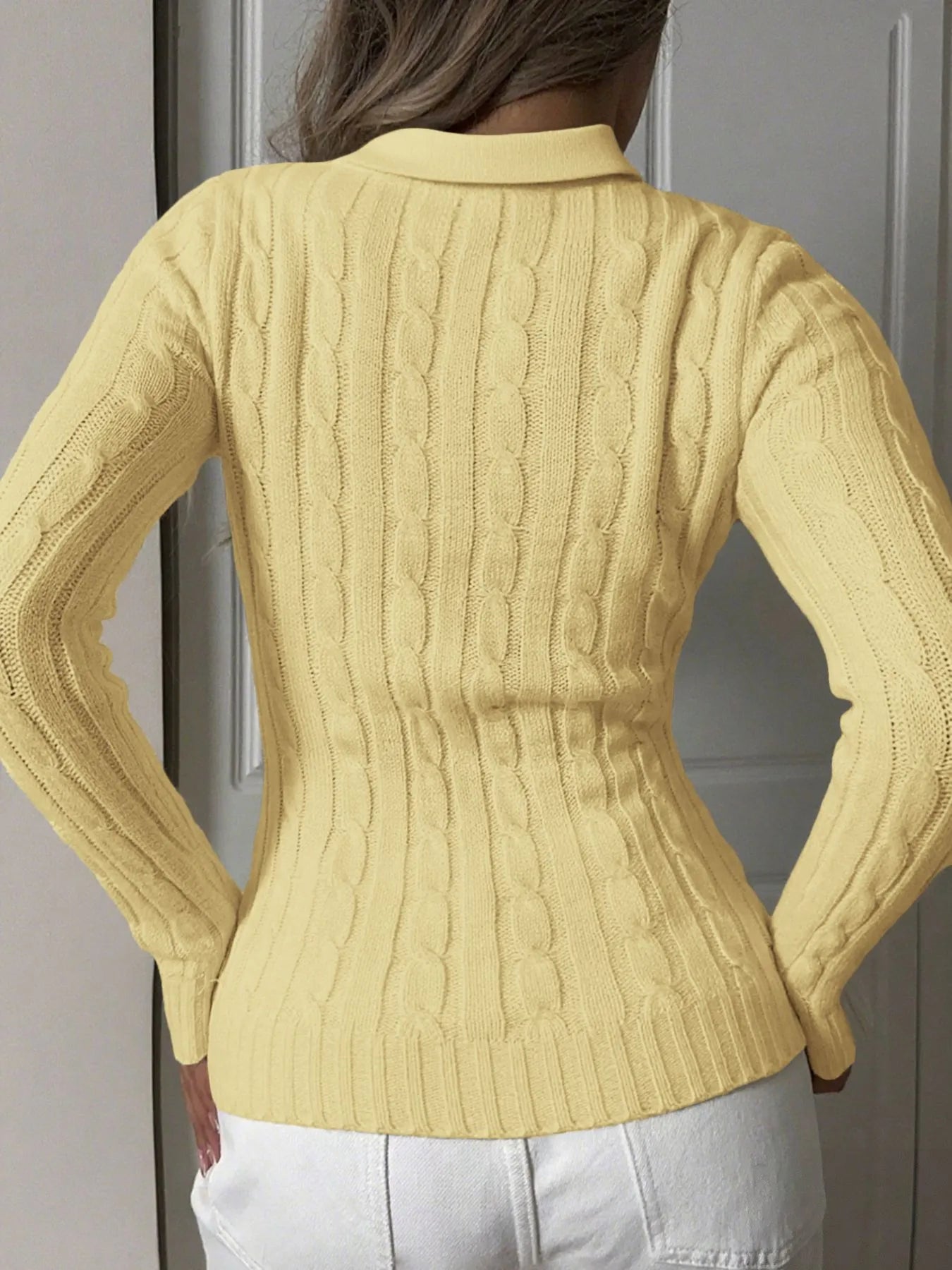 Yellow cable-knit long sleeve sweater back view with ribbed cuffs and hem