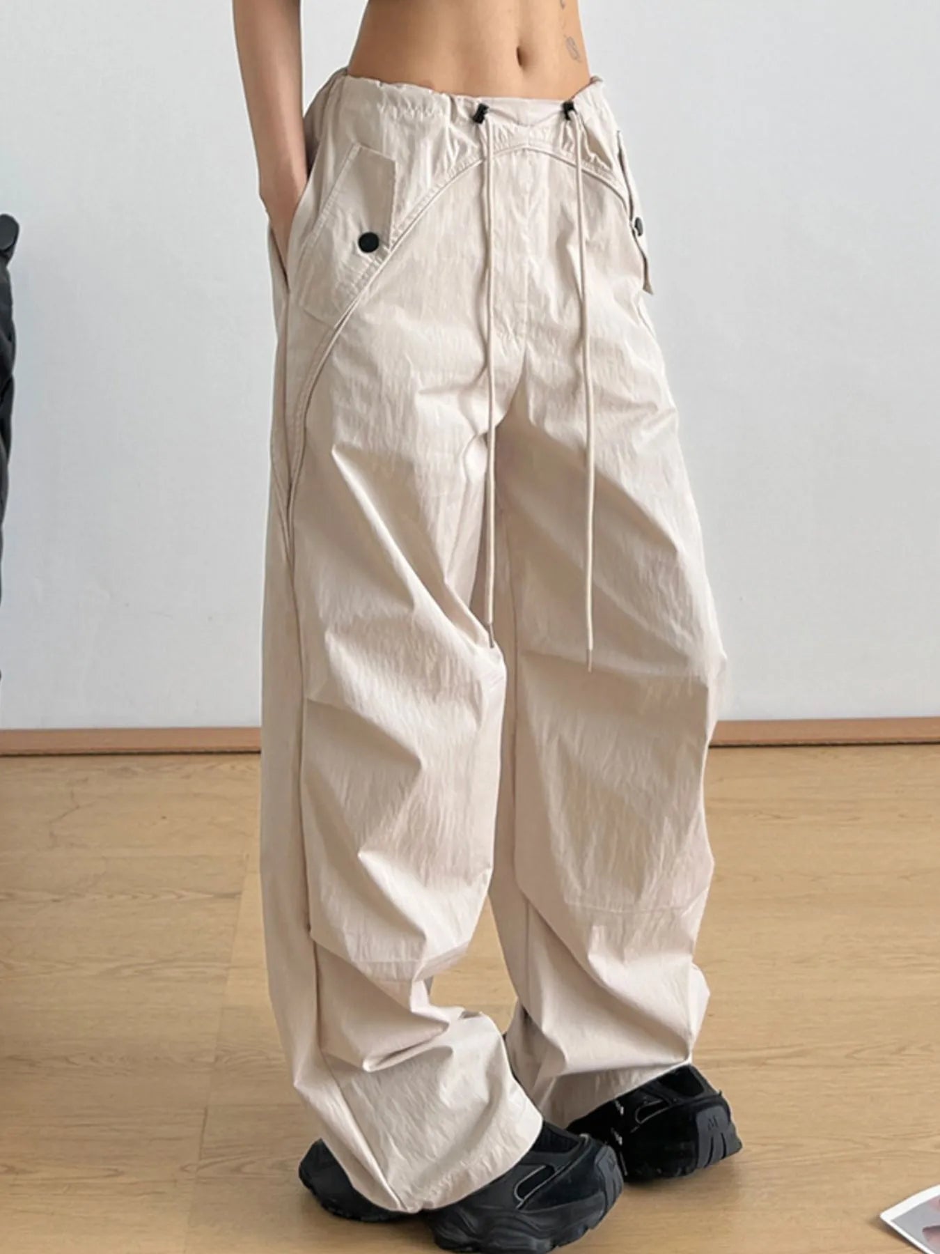 Beige relaxed wide-leg drawstring pants with elastic waistband and front pockets