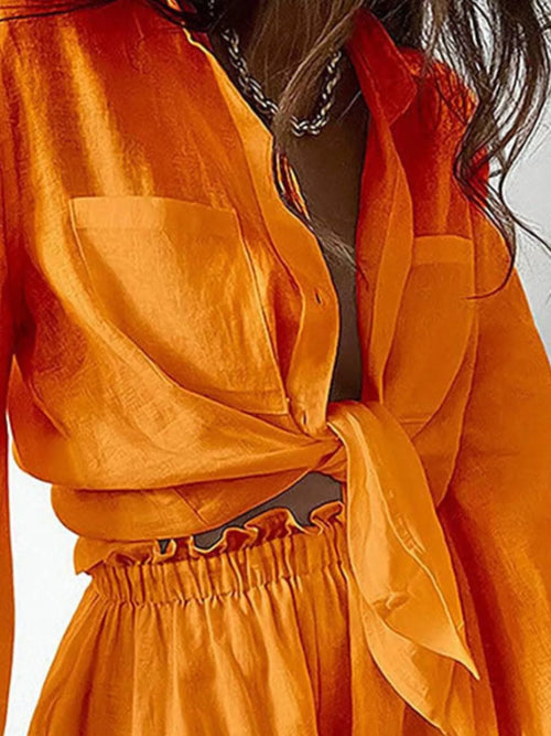 Tangerine button-up shirt top with matching ruffled shorts, front detail