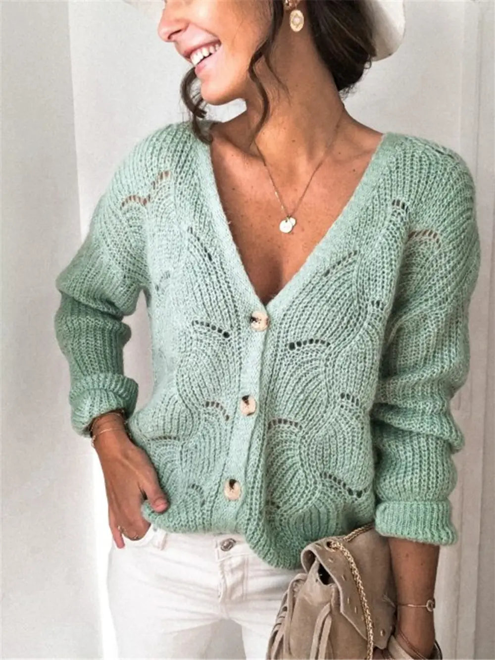 Light green openwork button-up cardigan with V-neck, long sleeves, and button front.