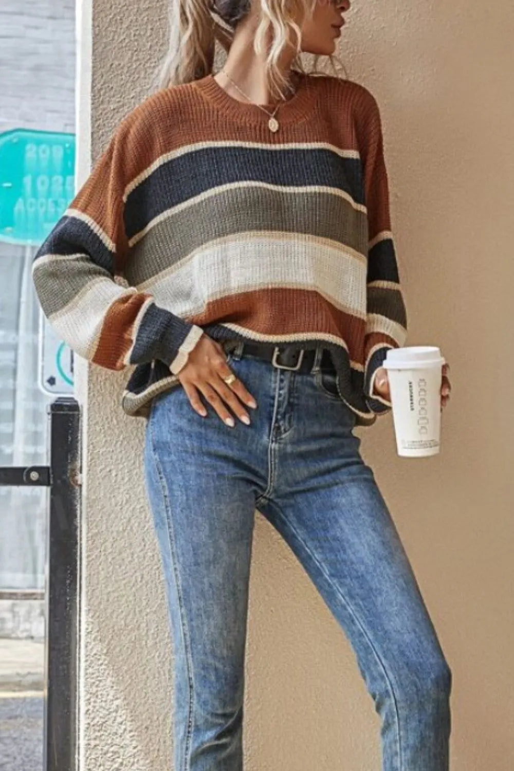Striped round-neck long-sleeve sweater in brown, navy, cream, and tan bands