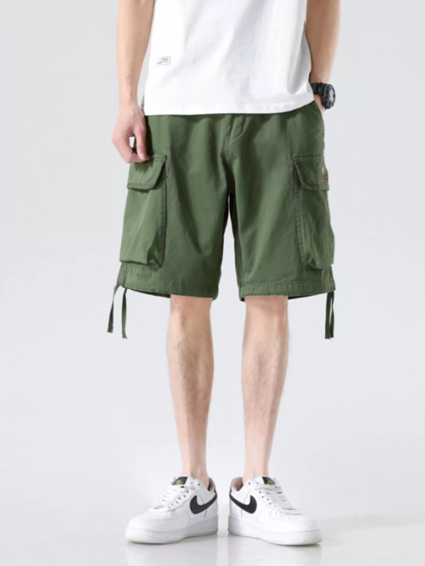 Military green cargo shorts with drawstring waist, side cargo pockets, hem hanging ties