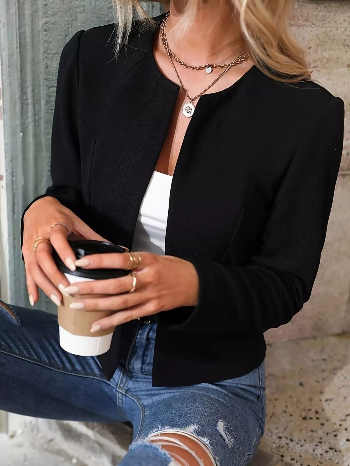 Black cropped open-front blazer with long sleeves and minimalist front lapels