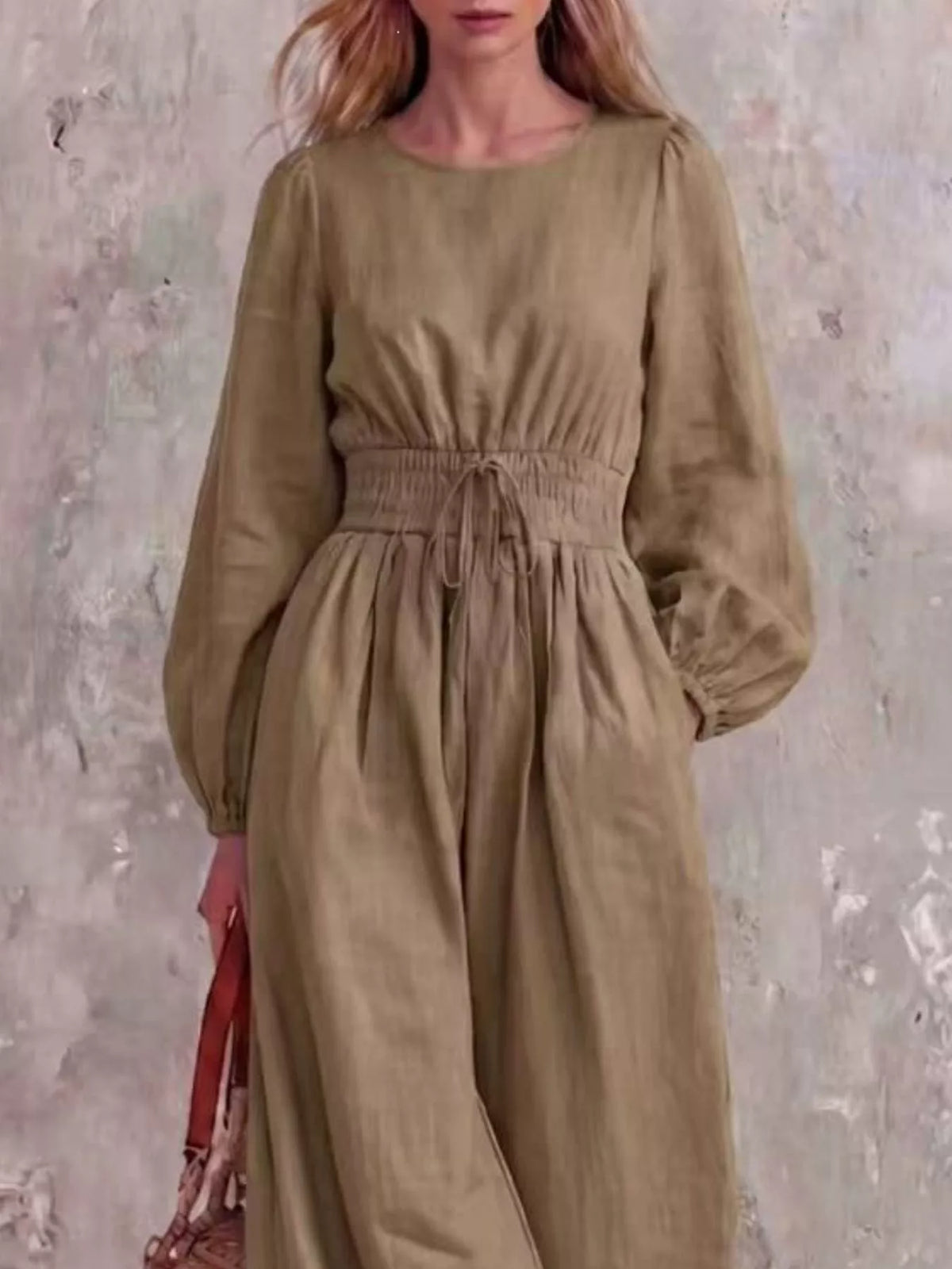 Smocked waist long-sleeve jumpsuit in khaki, full-length wide-leg fit