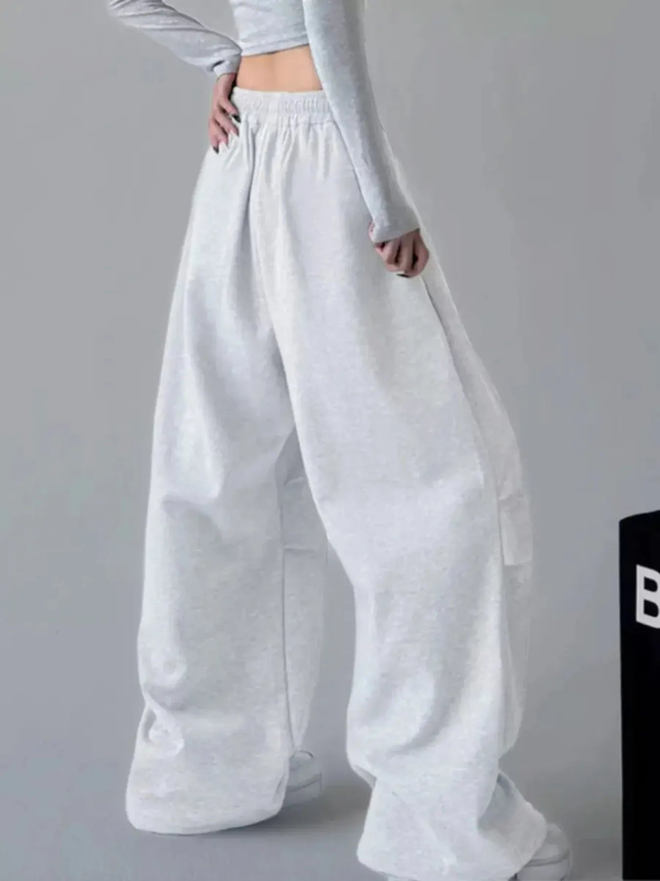 White oversized wide-leg drawstring pants with elastic waistband and roomy drape