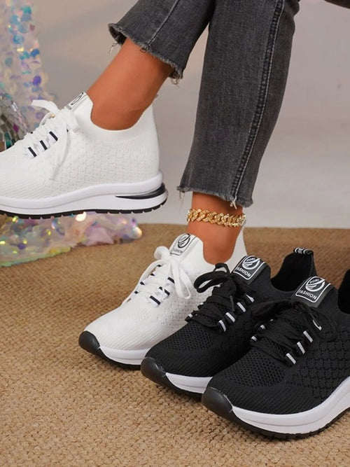 Mesh lace-up sneakers, white and black, with textured uppers and chunky soles