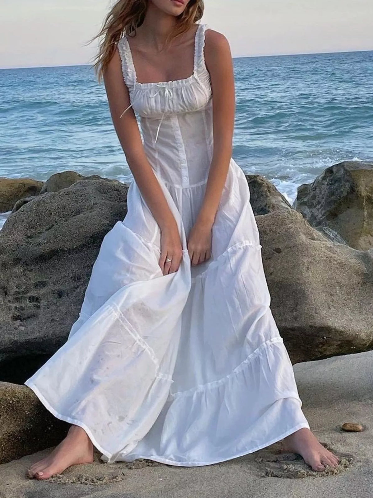 White cotton tiered maxi dress with ruffled square neckline and sleeveless bodice