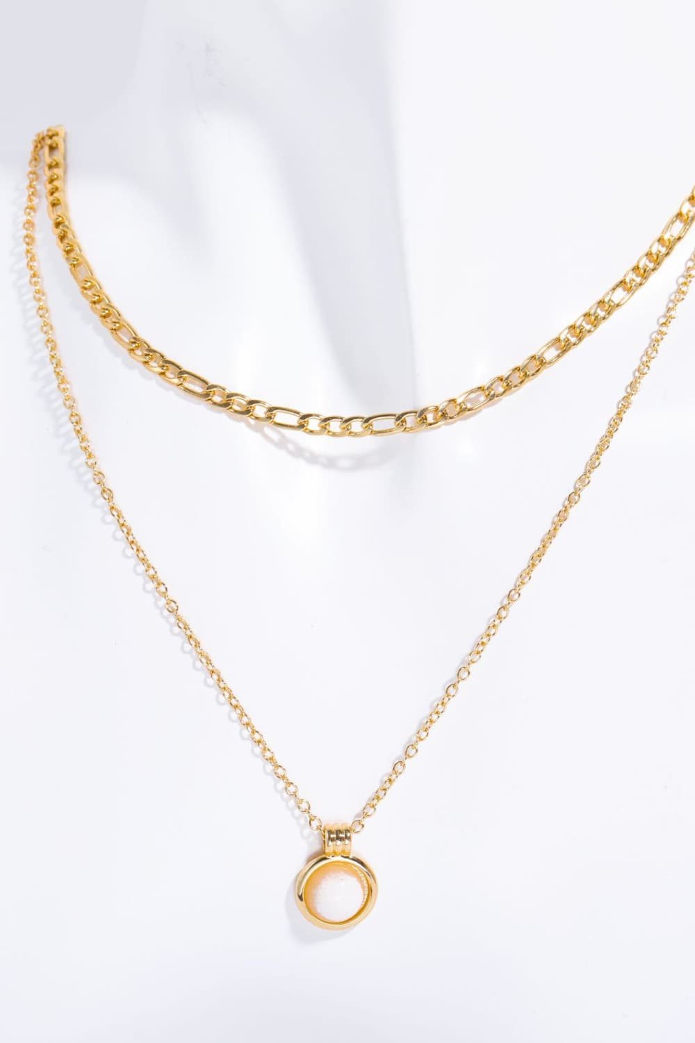 Gold-plated chain necklace with small round white pendant at center
