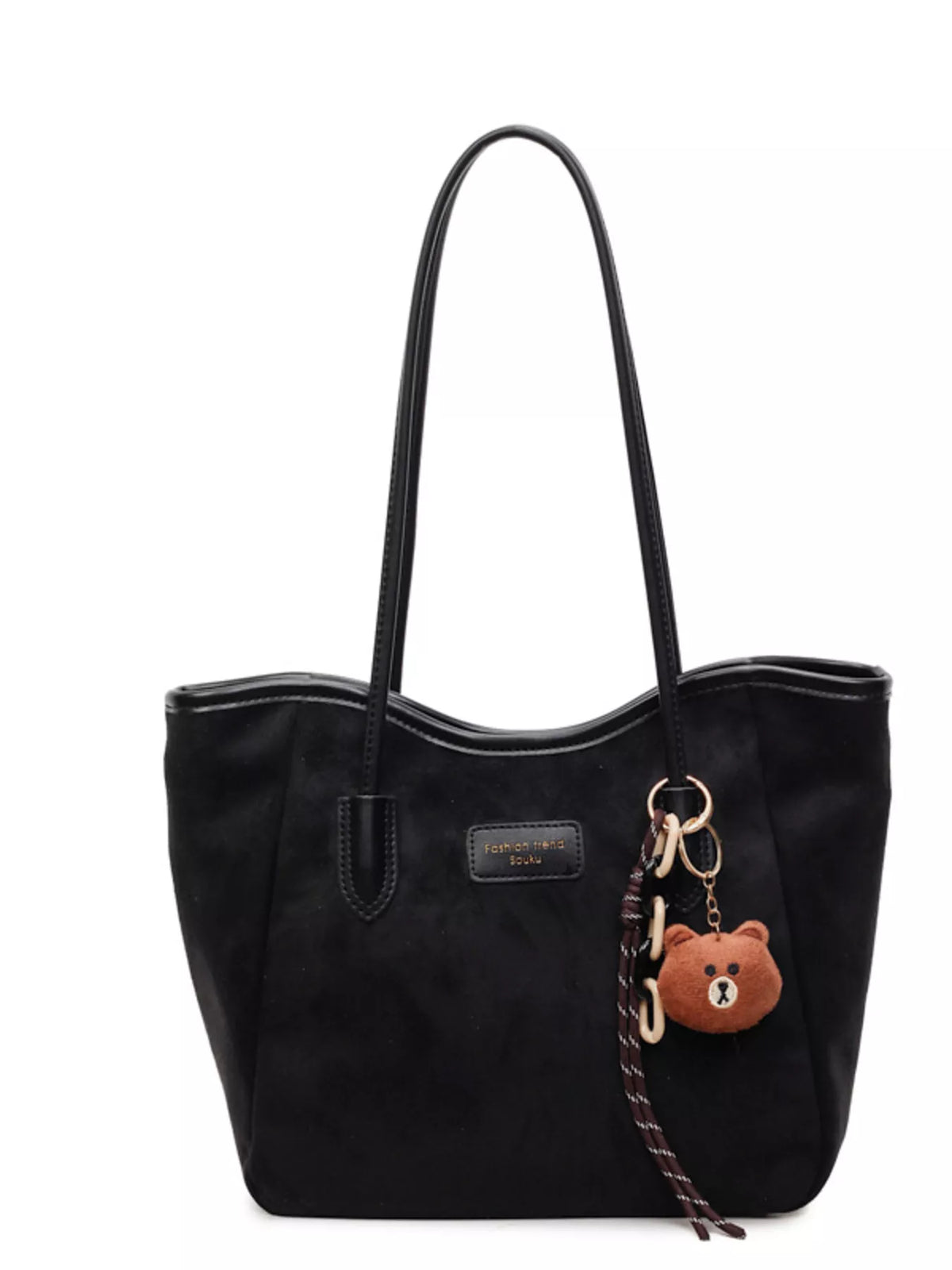 Black suede tote bag with long handles, front logo patch, and bear keychain charm