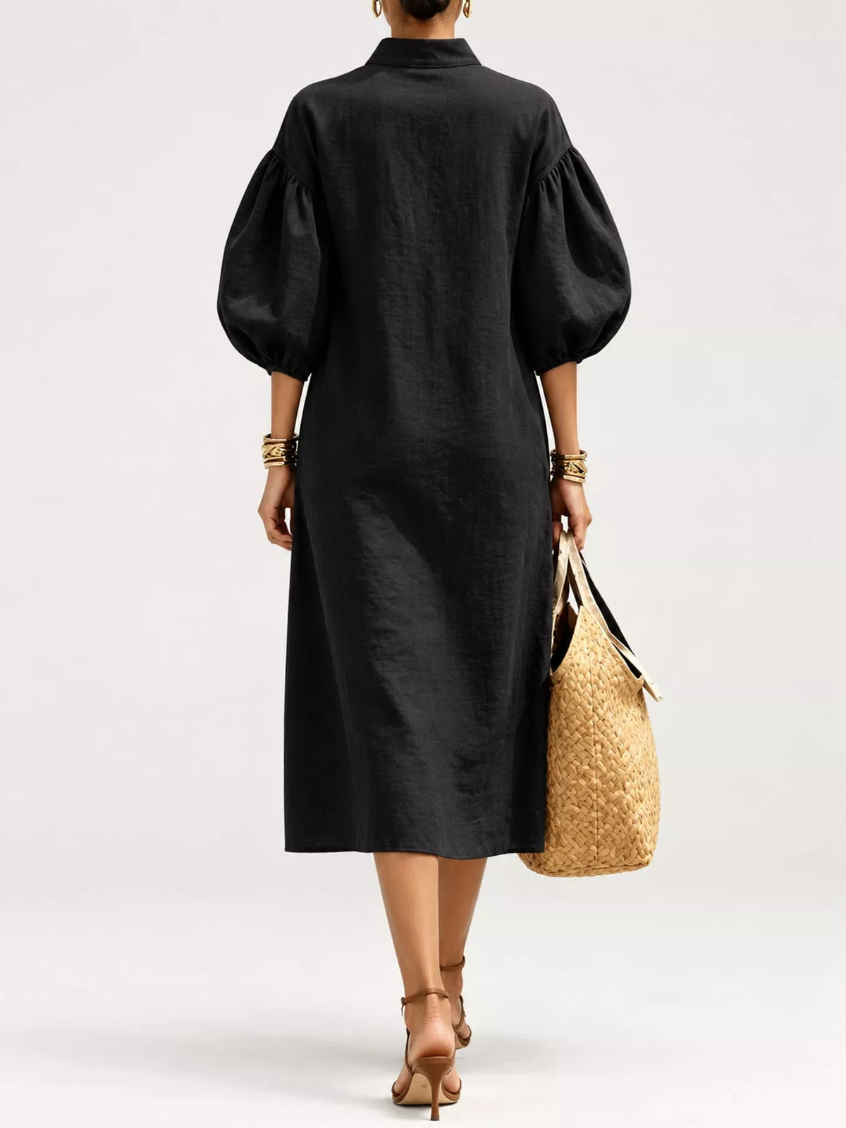 Black midi dress back view with puff sleeves and half-zip detail