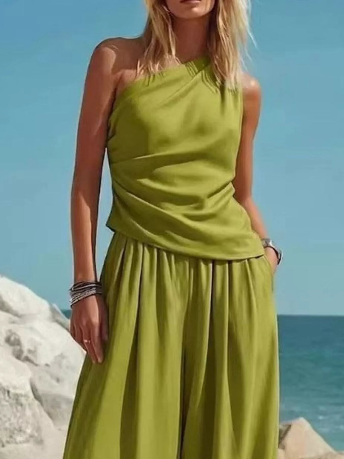 Green one-shoulder sleeveless top with gathered waist and matching harem pants