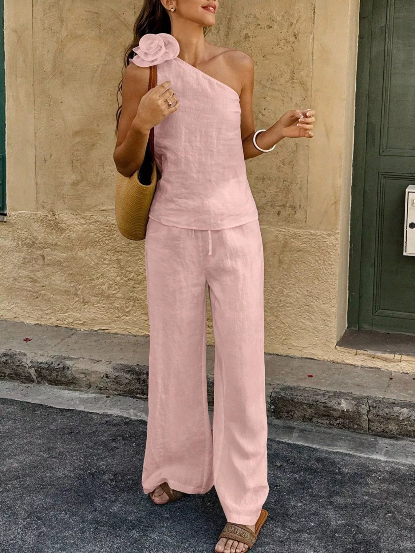 One-shoulder embellished top and pants set in pink with rosette and flowing wide legs