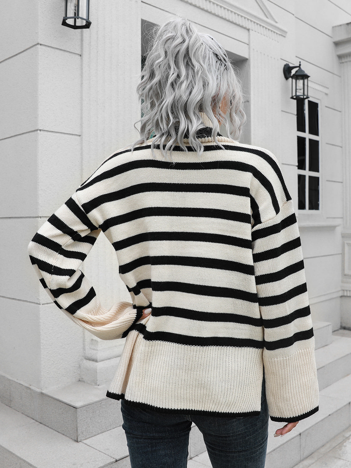 Black-and-white striped turtleneck sweater shown from the back, drop-shoulder style