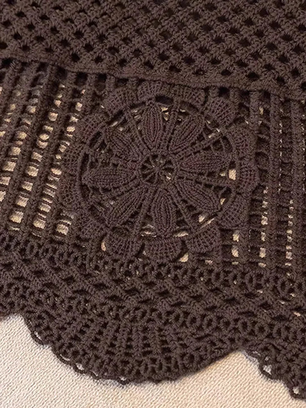 Dark brown crocheted tank yoke with central floral openwork motif and scalloped edge