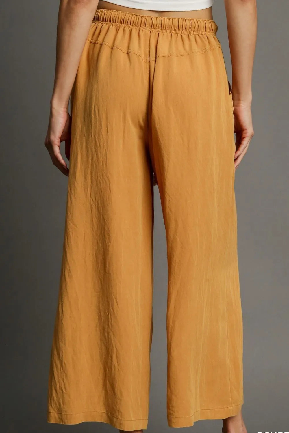 Mustard elastic-waist wide-leg pants with subtle vertical texture