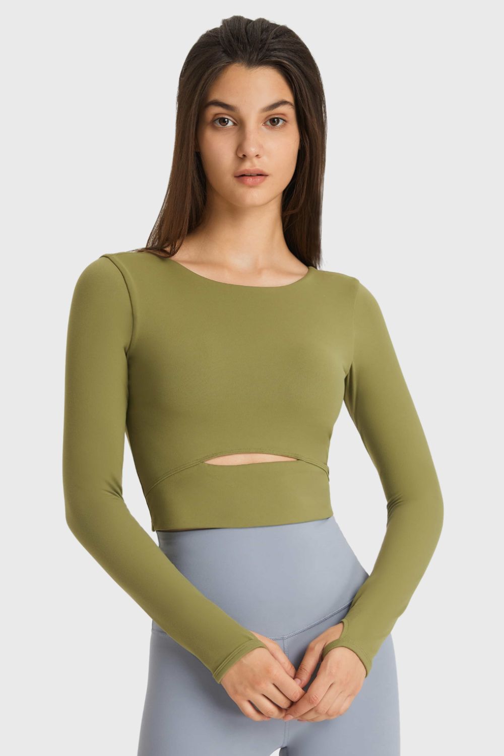 Olive green long-sleeve cropped sports top with waist cutout, front view