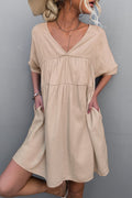 Apricot tiered V-neck mini dress with short sleeves and loose fit
