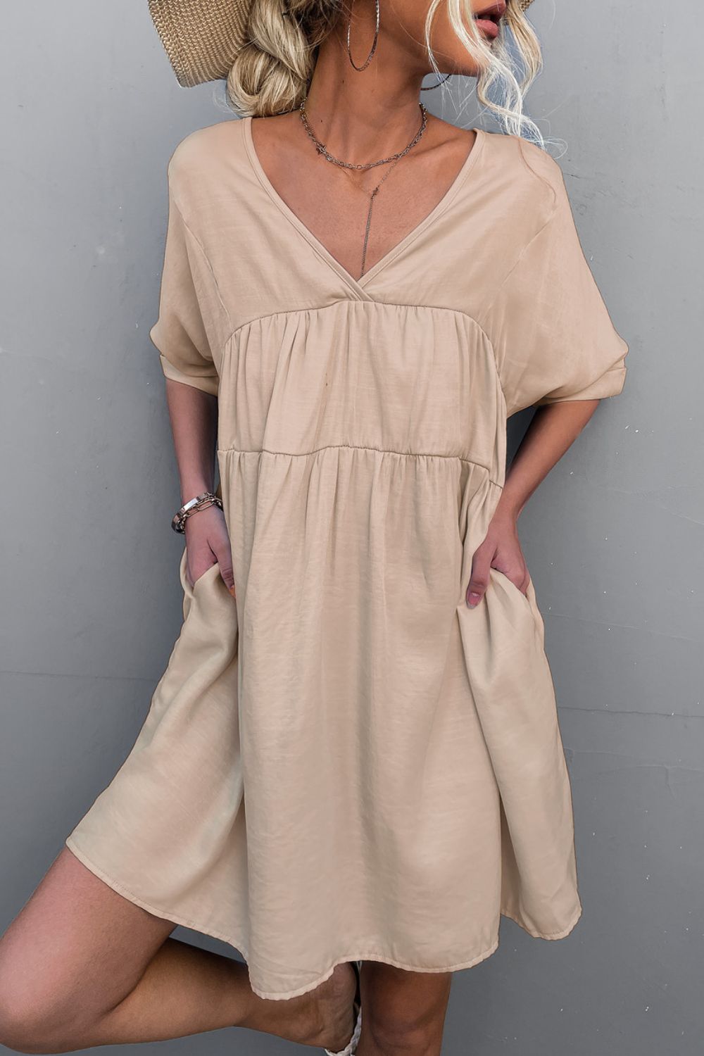 Apricot tiered V-neck mini dress with short sleeves and loose fit