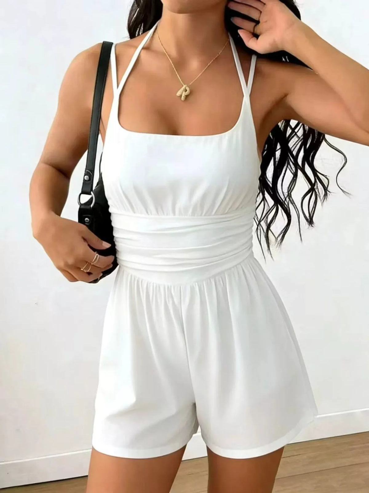 White ruched spaghetti-strap romper with gathered waist and short shorts