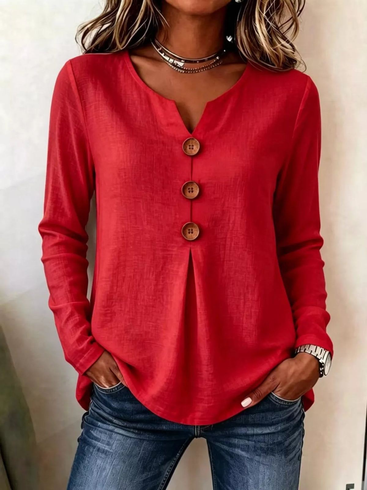 Red long-sleeve blouse with three decorative button placket and round neckline