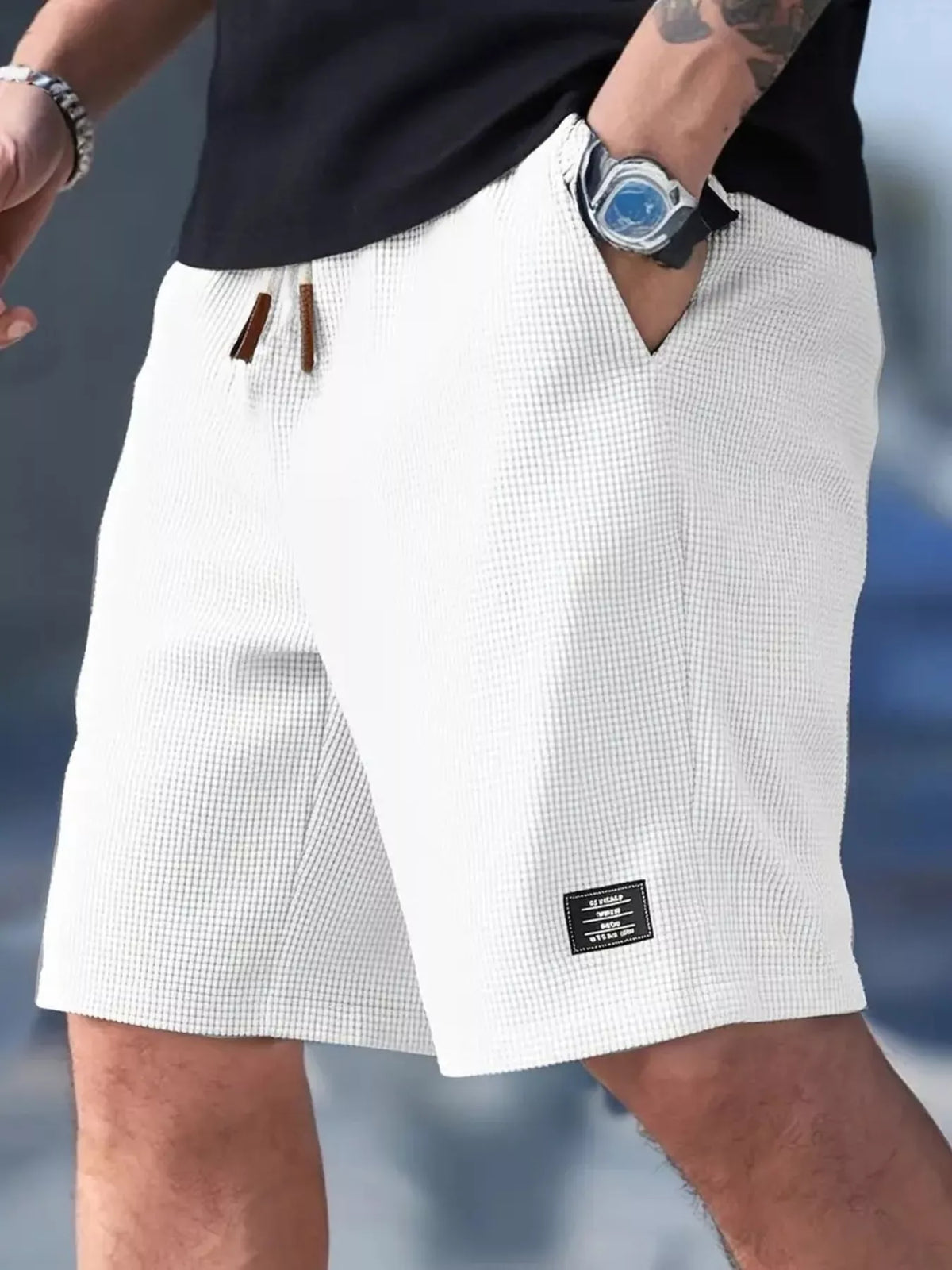 Waffle knit drawstring casual shorts in white, side view with logo patch