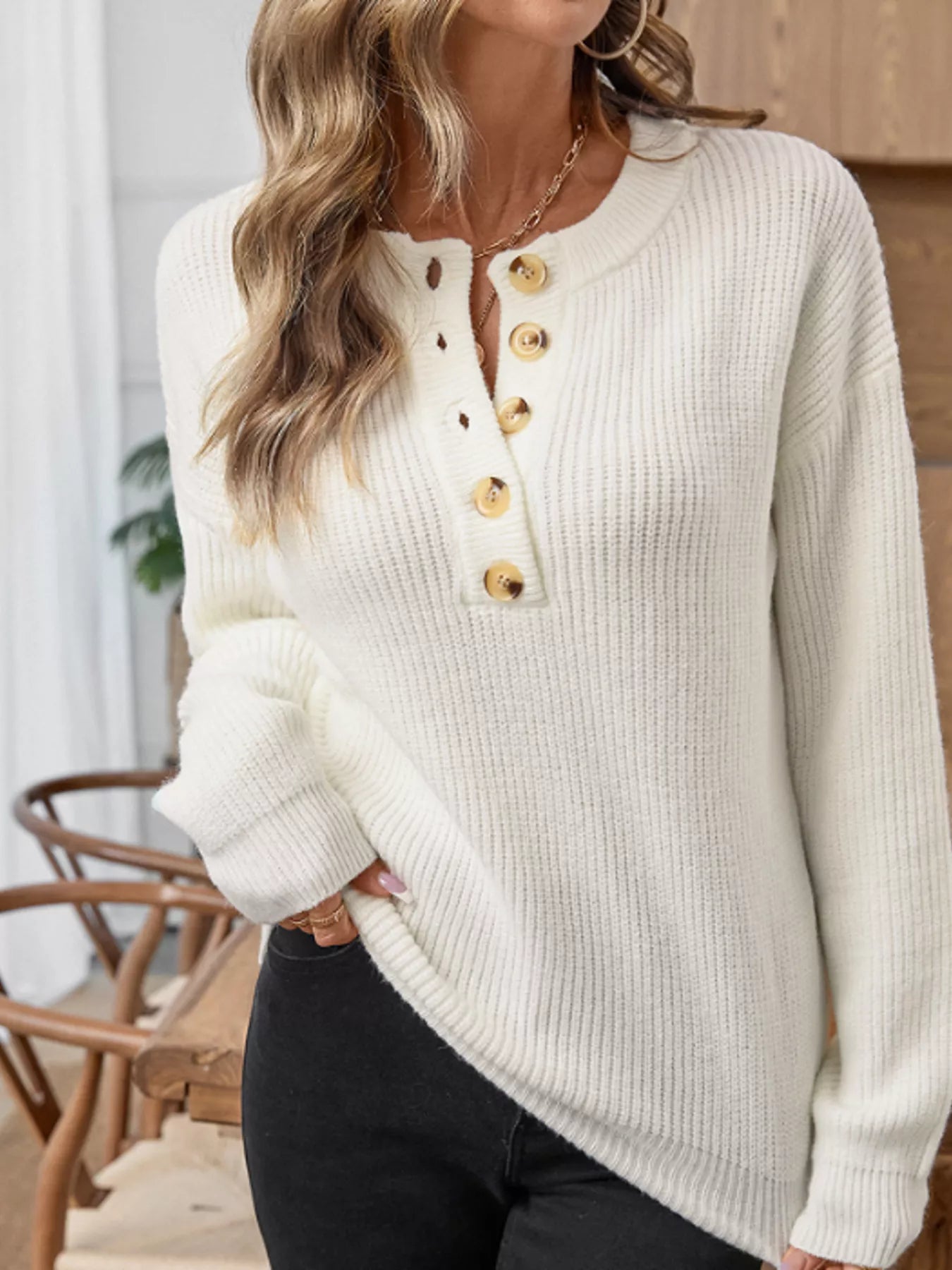 Cream long-sleeve sweater with ribbed knit and henley button placket