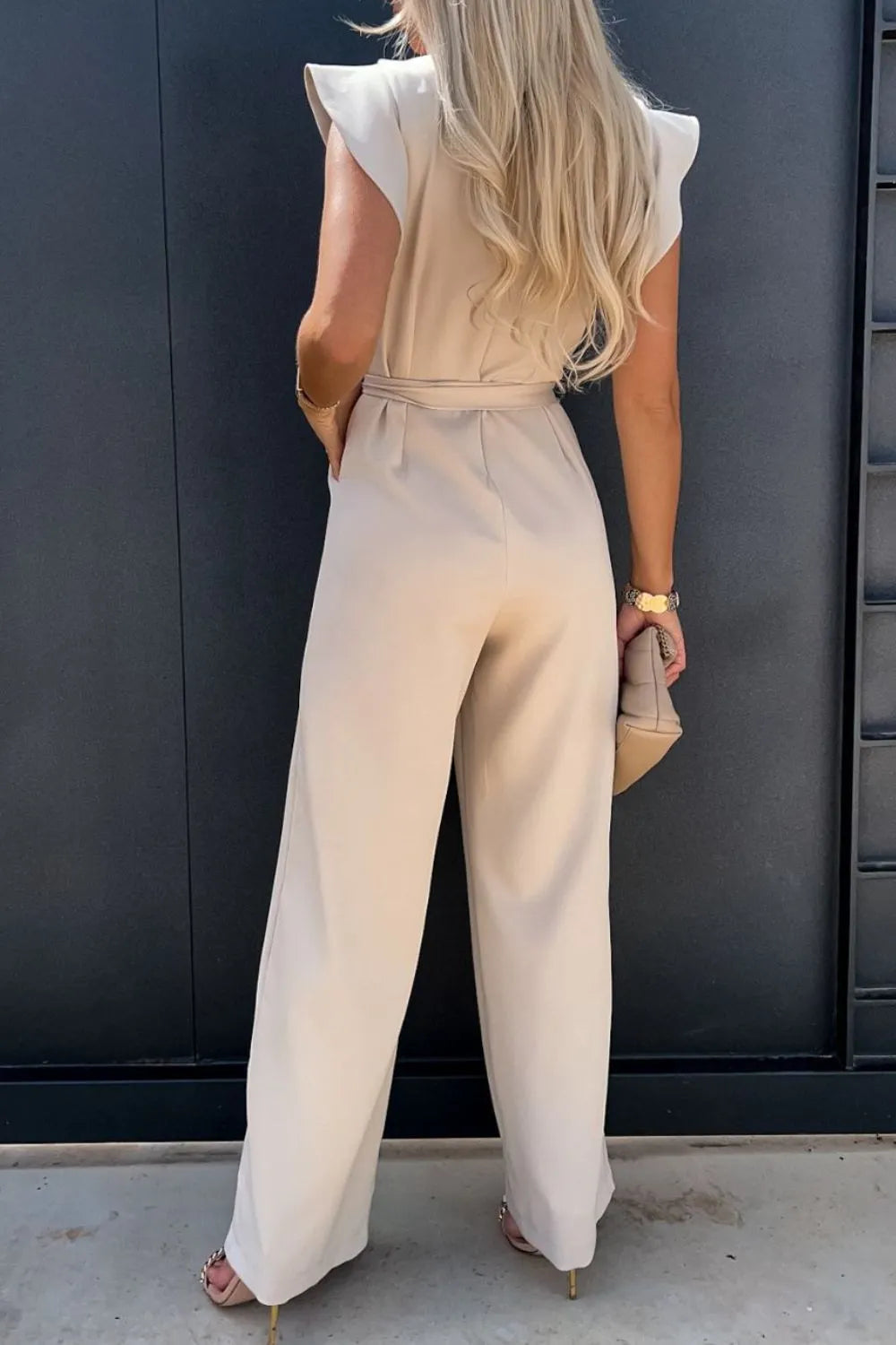Cream round-neck cap-sleeve jumpsuit with waist tie and relaxed wide-leg fit