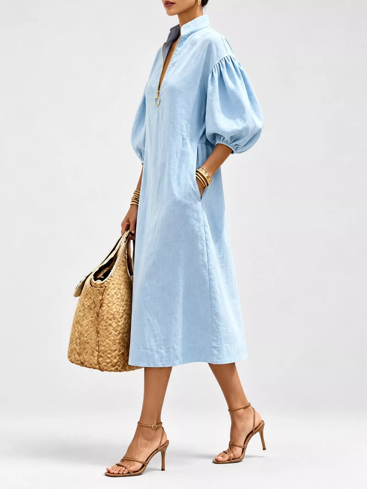 Light blue half-zip midi dress with voluminous puff sleeves and gathered shoulders