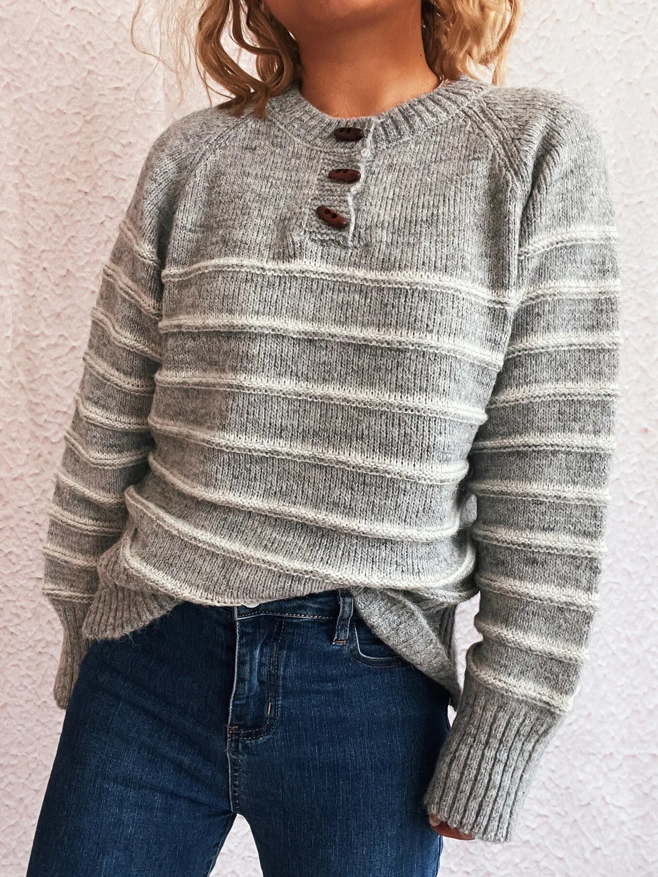 Gray striped knit long-sleeve sweater with button placket at the round neckline