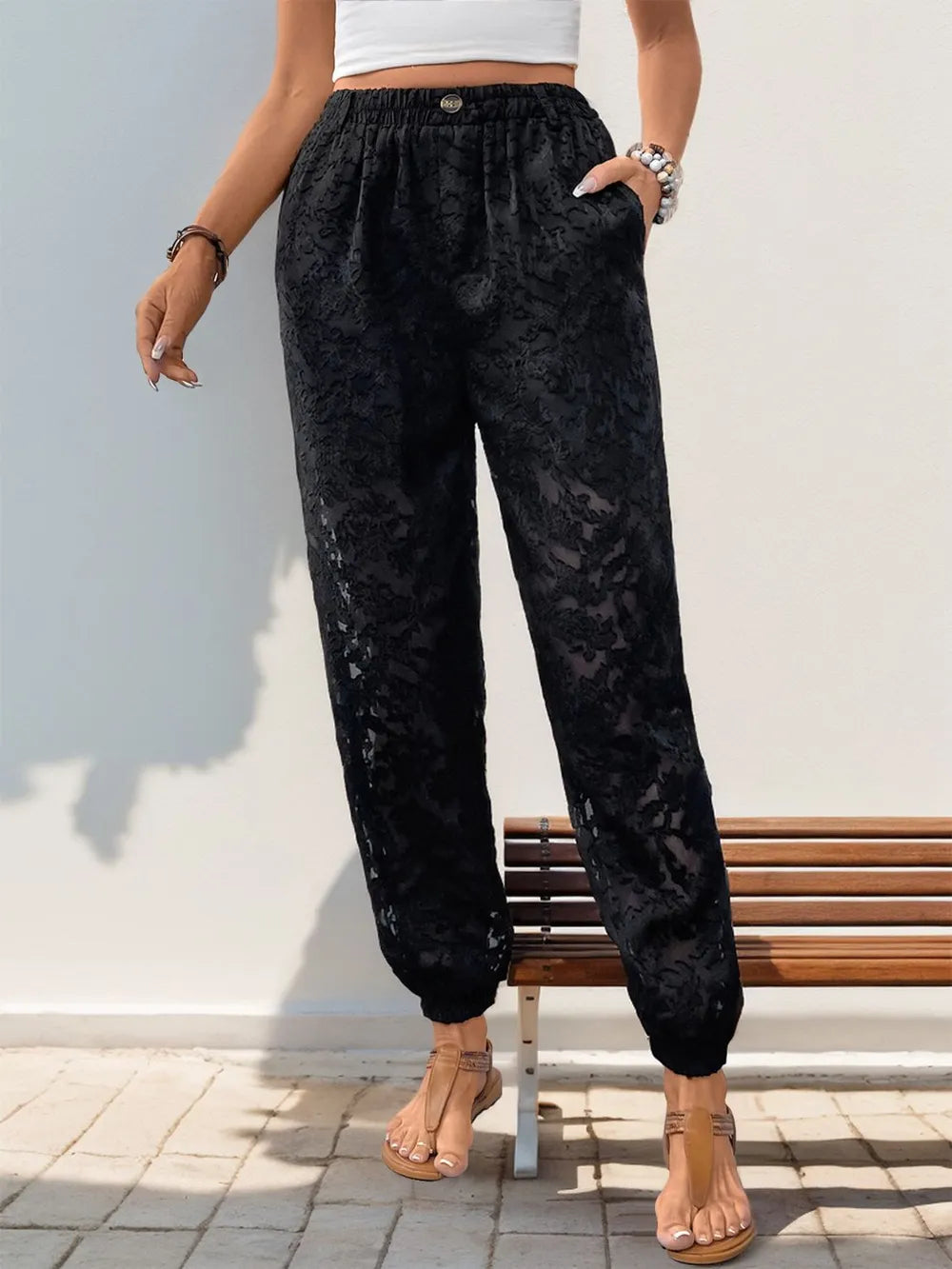 Black lace elastic-waist pants with front pockets and relaxed straight fit
