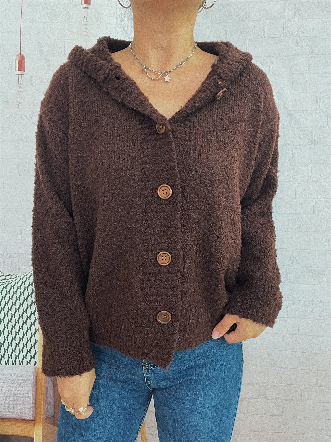 Brown hooded cardigan with long sleeves, textured knit, and front button placket
