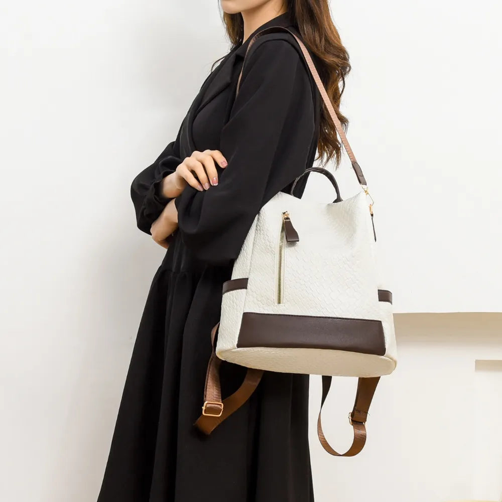 Vegan leather mini backpack bag in ivory with brown trim, top handle and adjustable strap