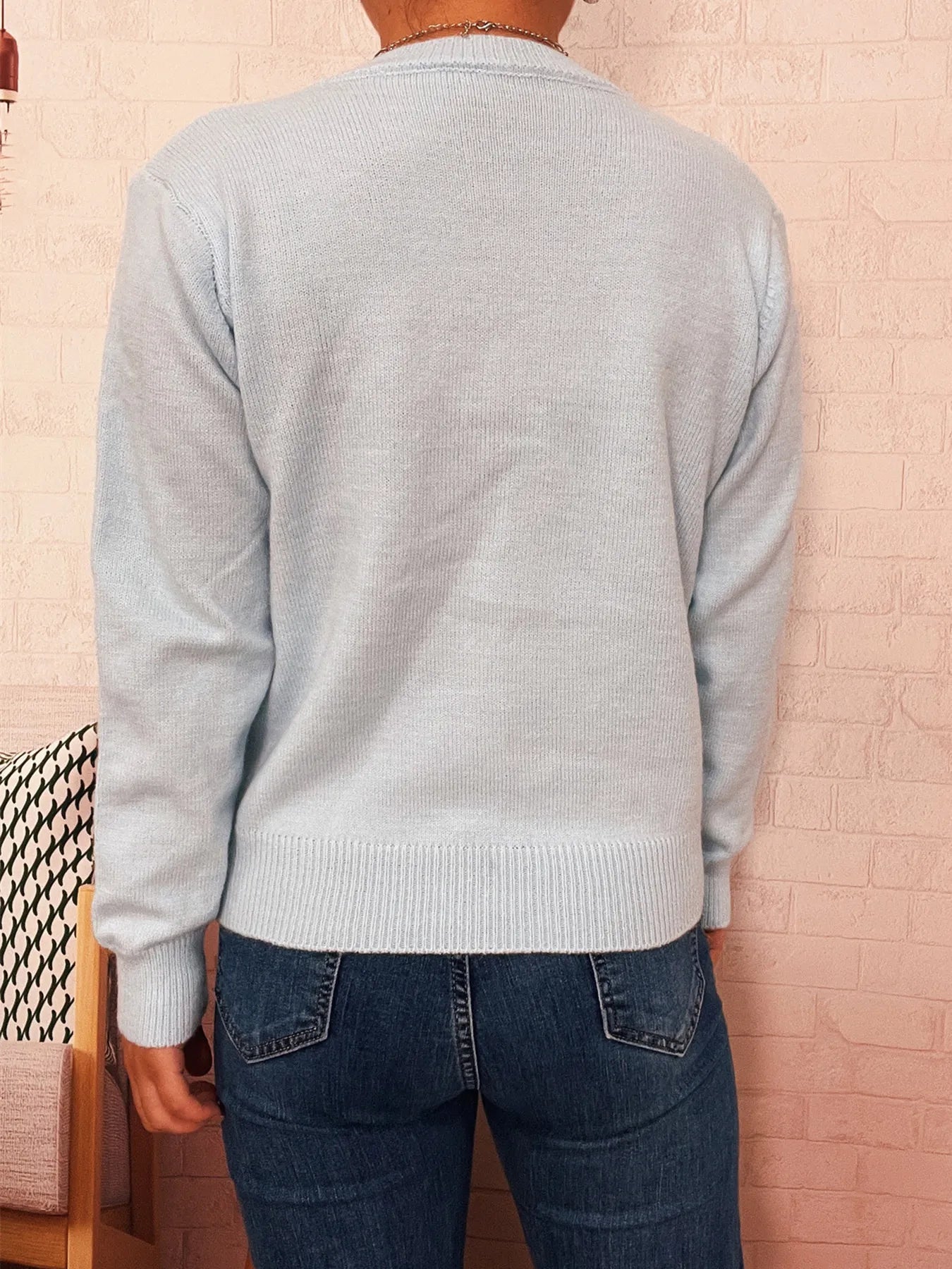 Light blue knit cardigan, long-sleeve with ribbed hem and neckline, back view