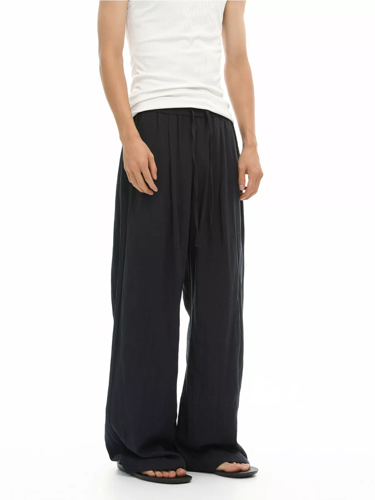 Black relaxed wide-leg pants with gathered waistband and side pockets