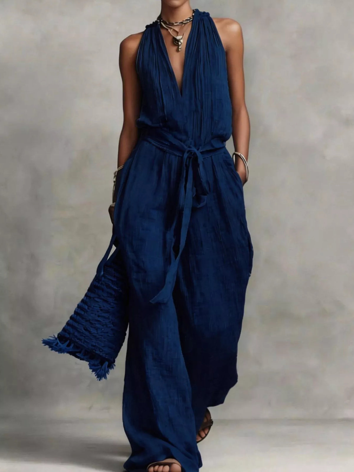 Navy sleeveless wide-leg jumpsuit with V-neck and tie waist belt