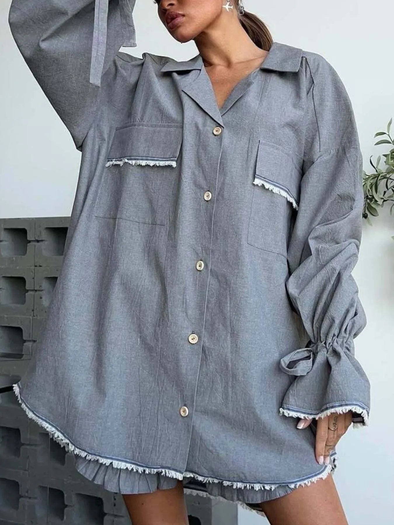 Dark gray button-up flounce-sleeve top with ruffled-trim pockets and shorts set
