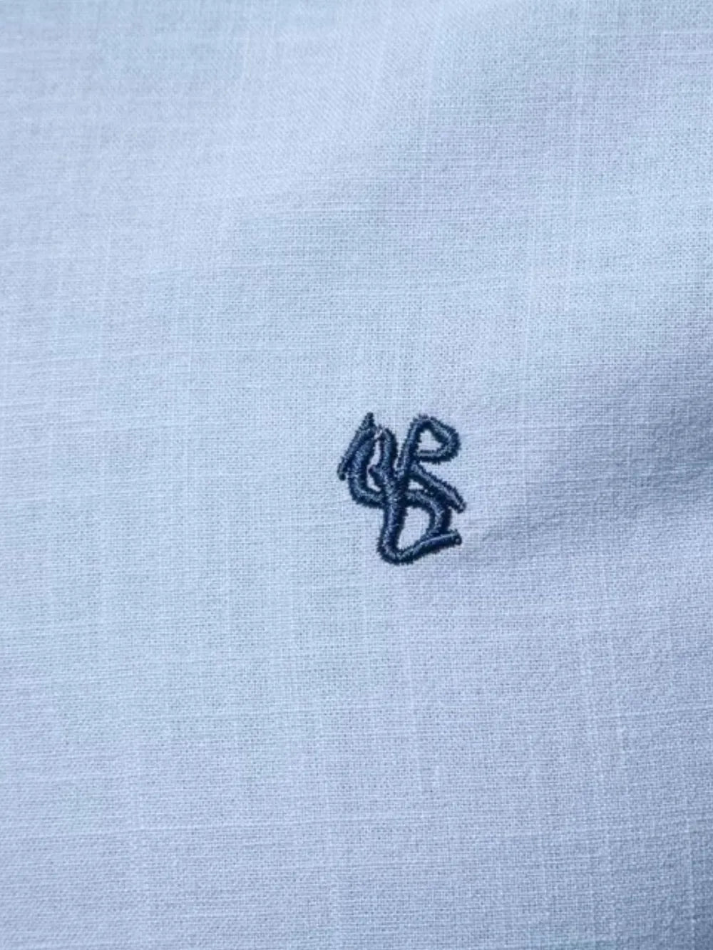 Men's light blue button-down shirt with small embroidered chest logo