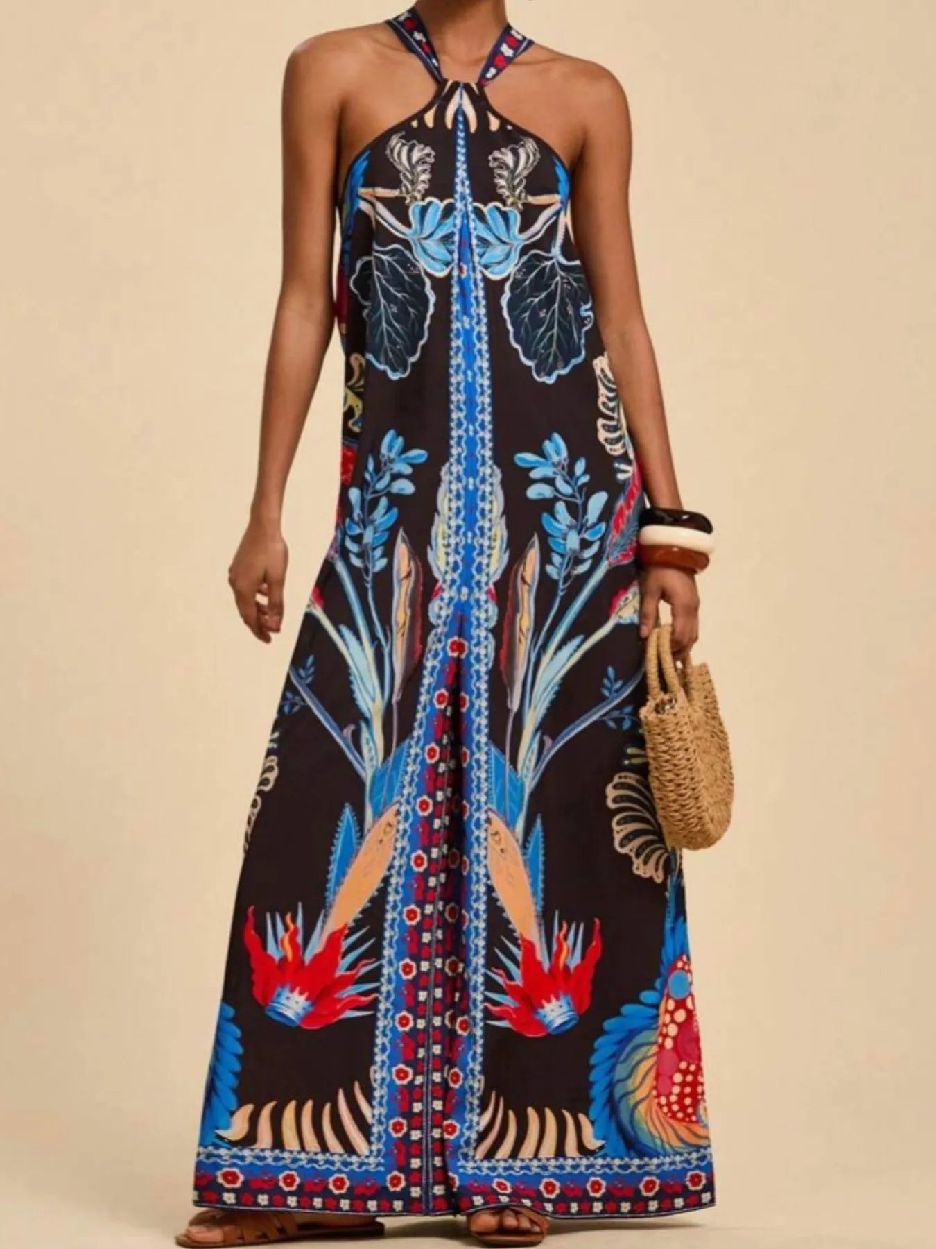 Black halter wide-leg jumpsuit with botanical border print and crisscross neckline