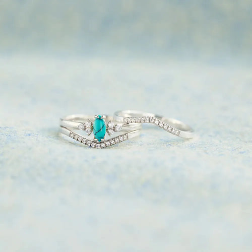 Silver ring with V-shaped turquoise teardrop inset and sparkling zircon bands