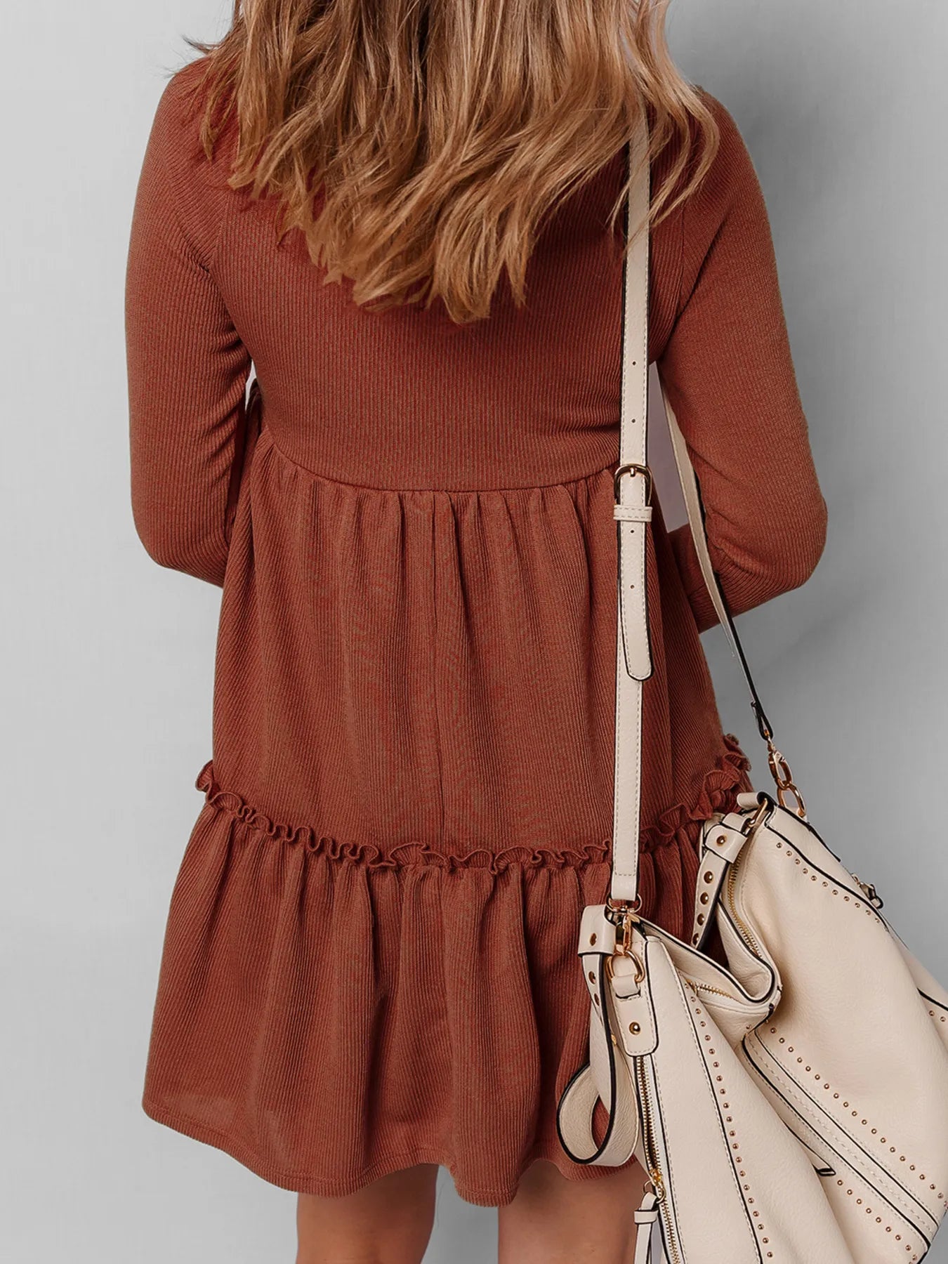 Frill Tiered Long Sleeve Mini Dress in rust with two cream crossbody bags