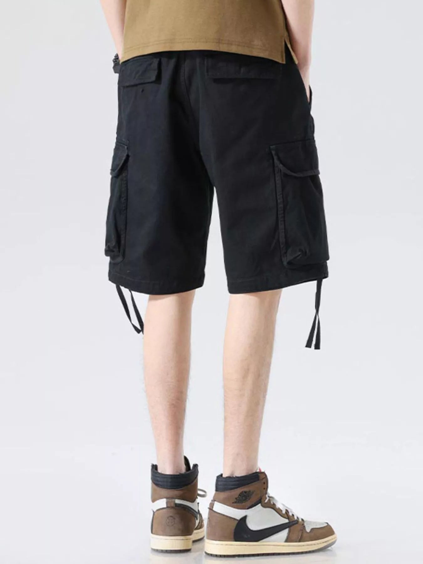 Black cargo shorts with cargo pockets and drawstring ties at hem, wide-leg silhouette
