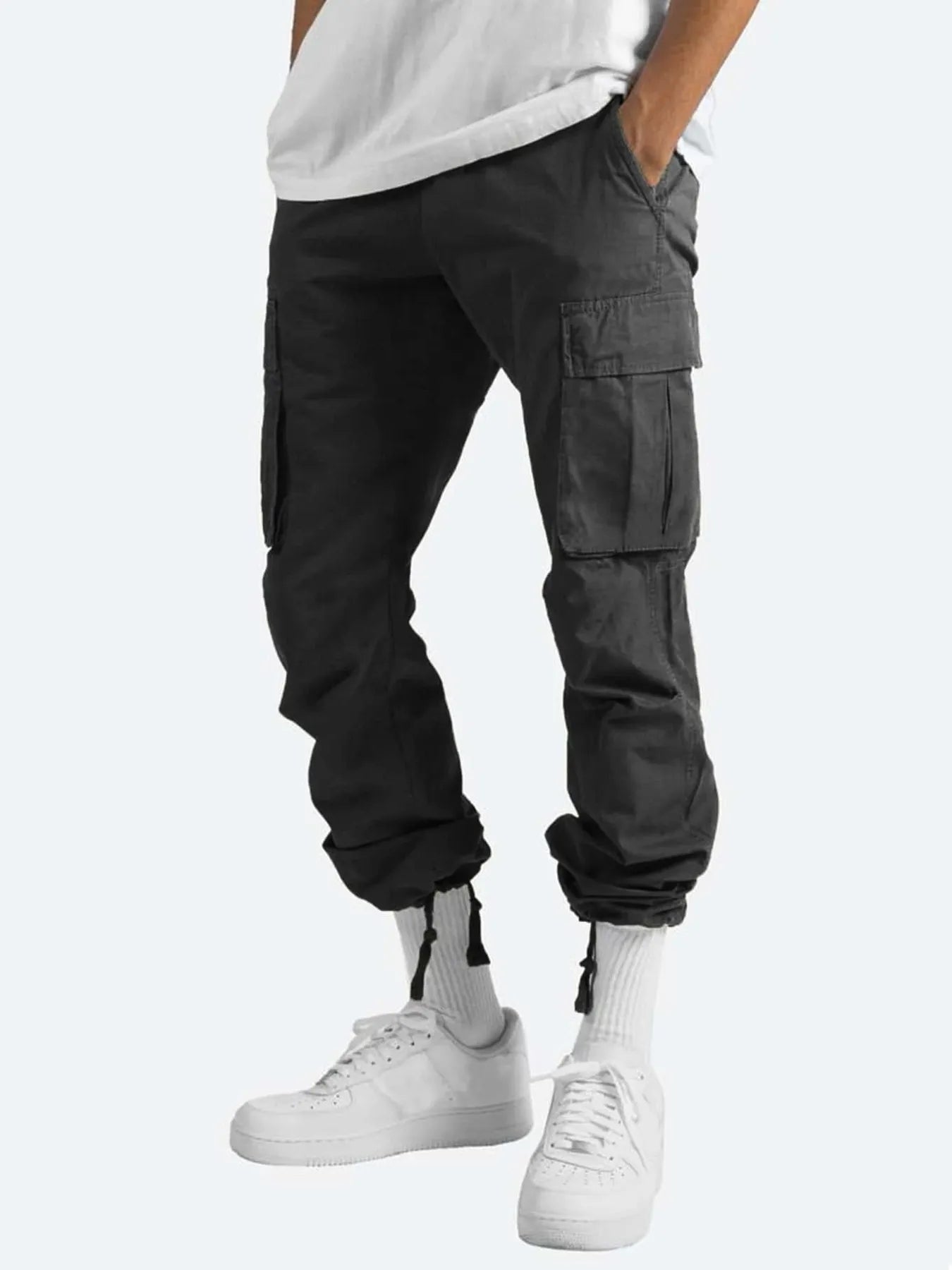 Men's black cargo pants with flap cargo pockets and drawstring cuffs at ankles.