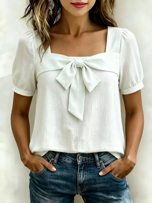 White square-neck blouse with puff sleeves and a bow-tie at the chest