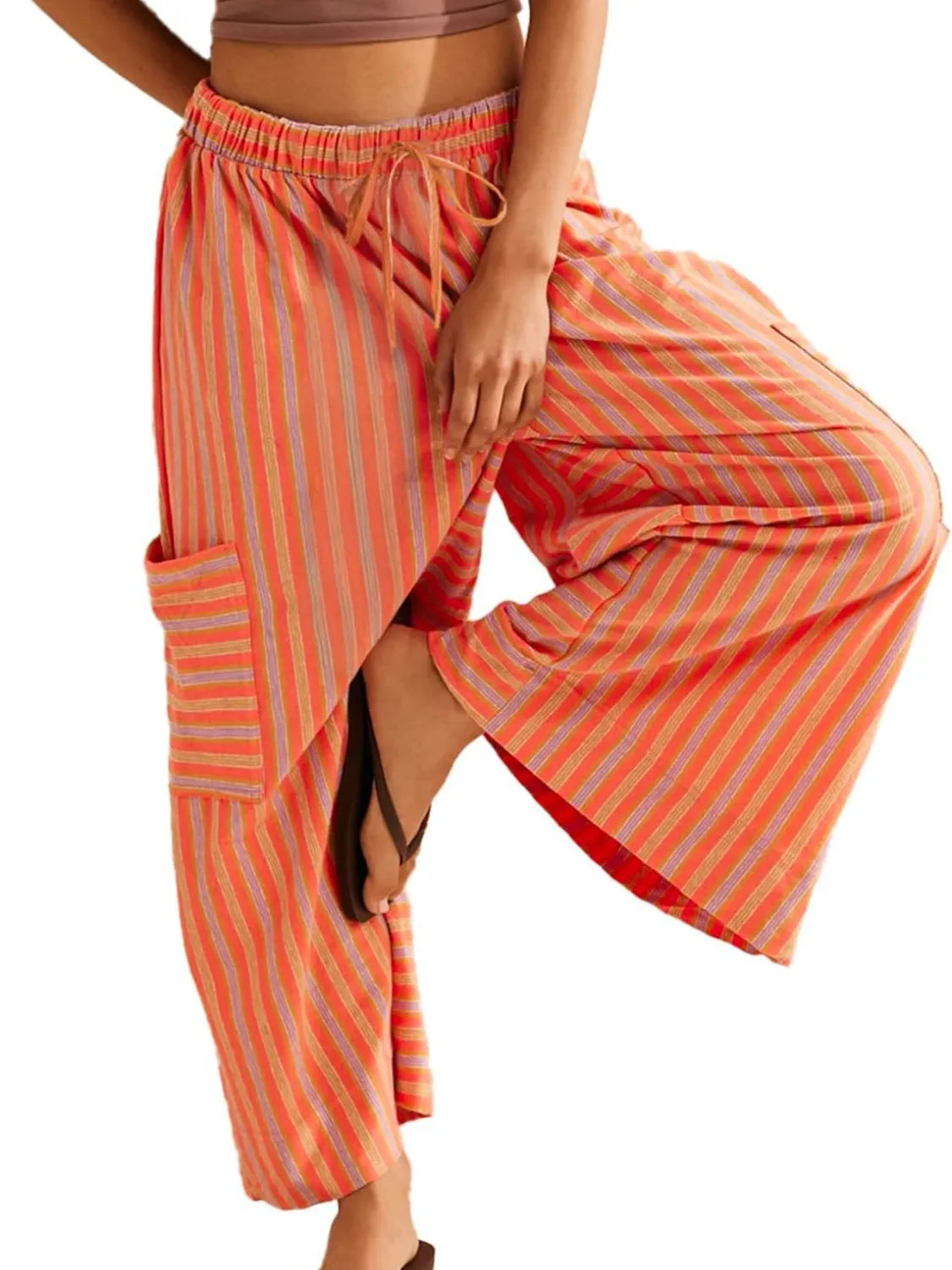 Tangerine orange striped wide-leg pants with tie waist and contrast pocket panel detail