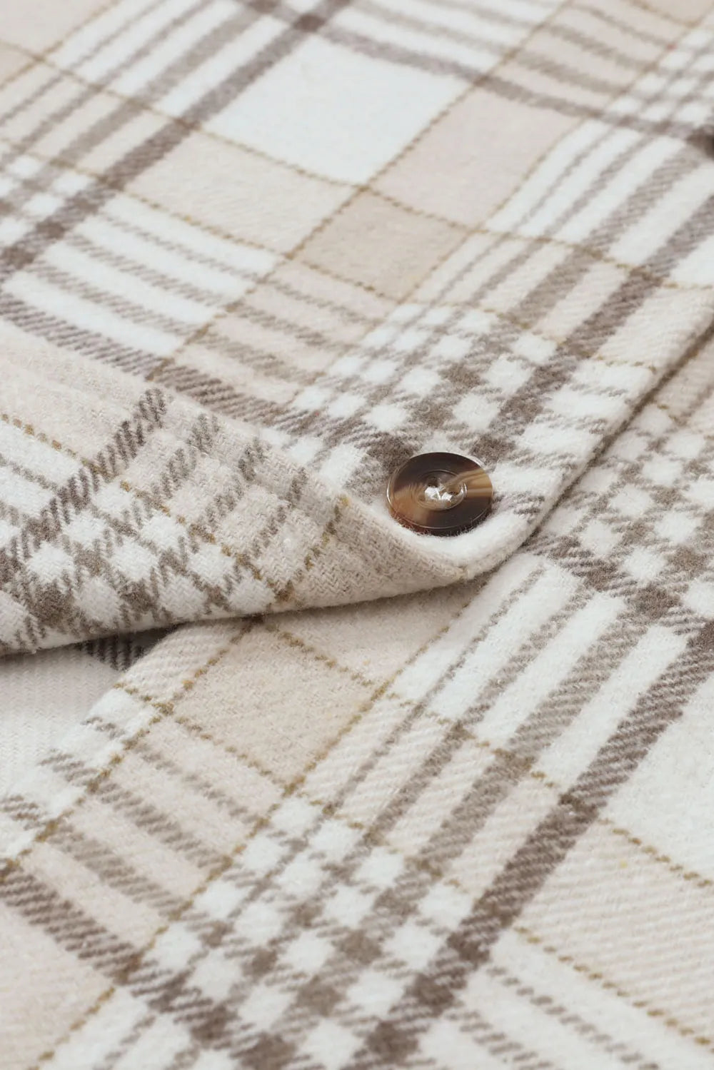 Plaid shacket front panel with round brown button, beige and brown grid