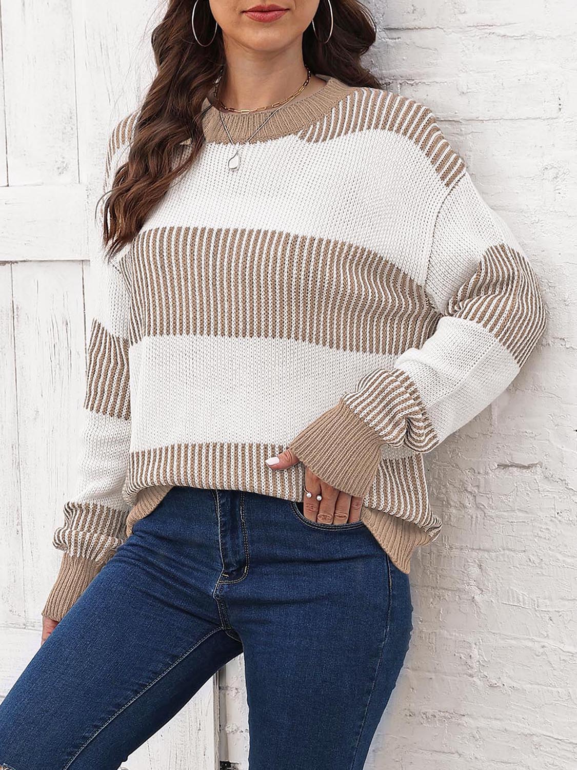 Striped knit drop-shoulder sweater with round neck, cream body and tan horizontal bands