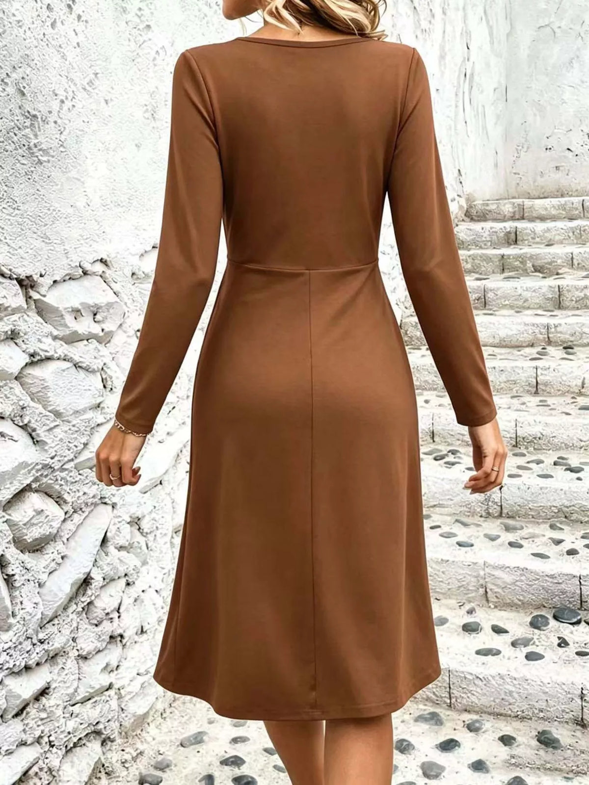 Tan back view of ruched midi dress with long sleeves and fitted waist seam.